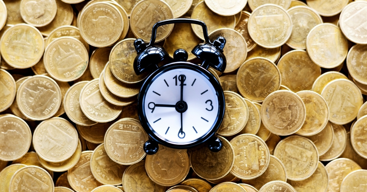 clock alarm on top of coins