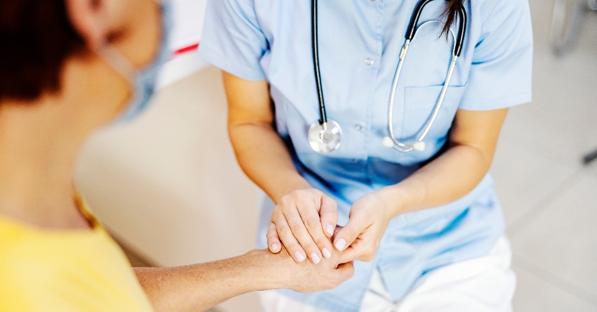  female doctor comforting patient at doctor's office