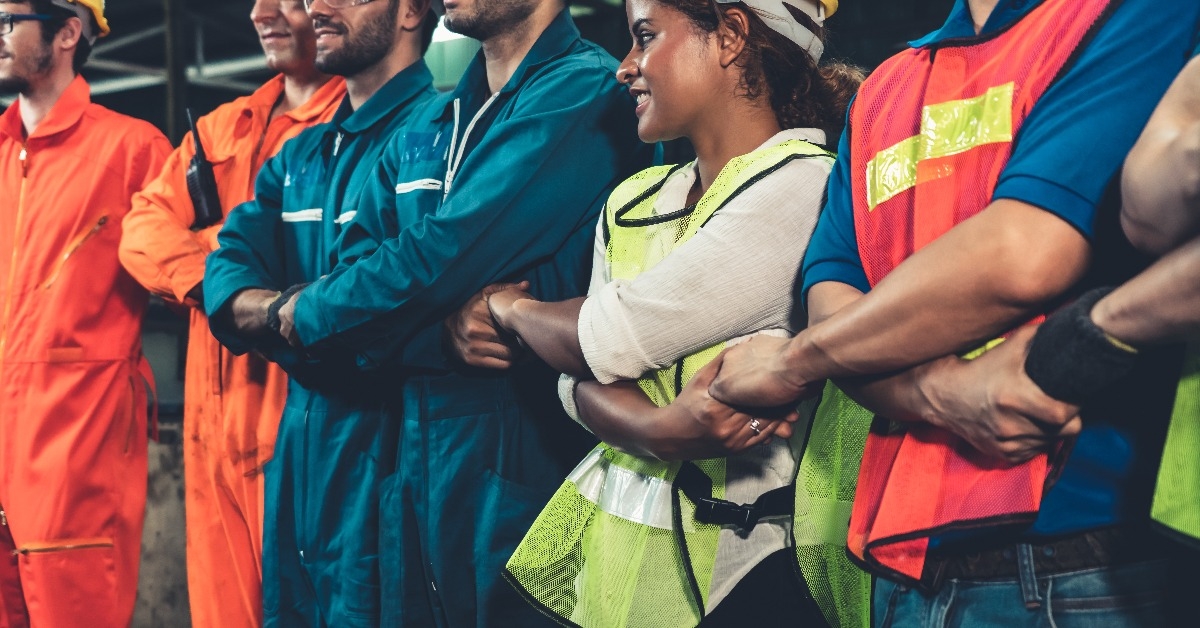 Skillful worker stand together showing teamwork in the factory 