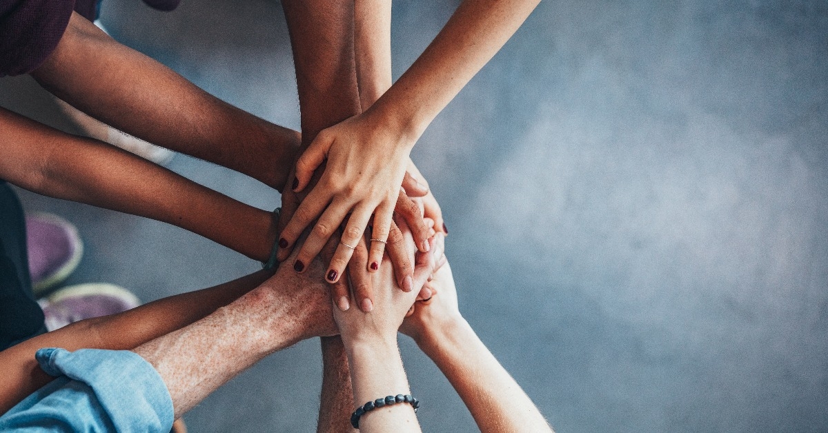 Stack of hands showing unity and teamwork