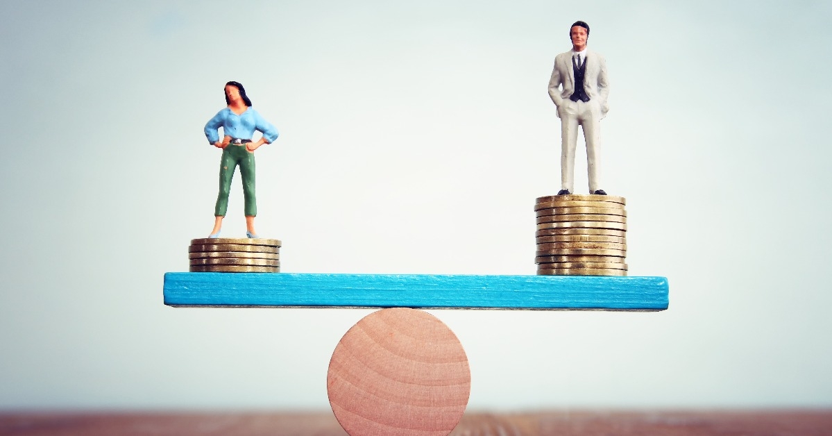  woman and a man on either side of the scales