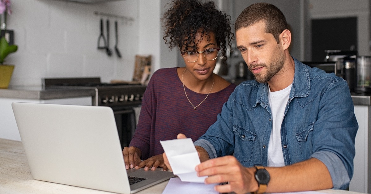 Young multiethnic couple examining home finance