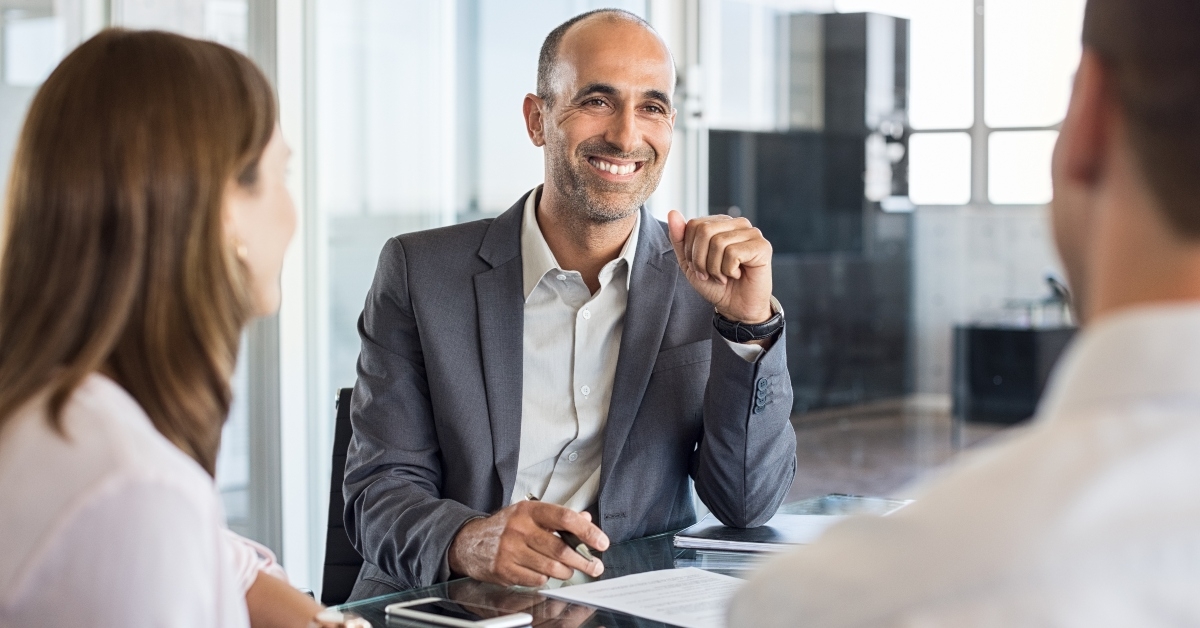 Couple talking with financial planner