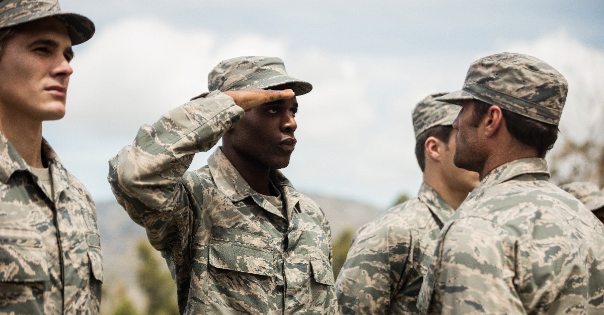 Mixed race military trainer giving training to military soldier