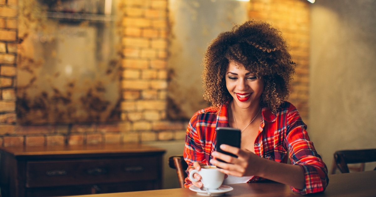 Smiling woman looking at phone