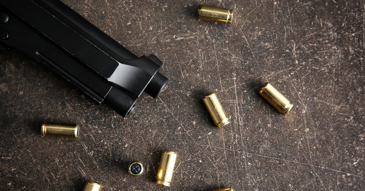 Bullets and gun on gray table