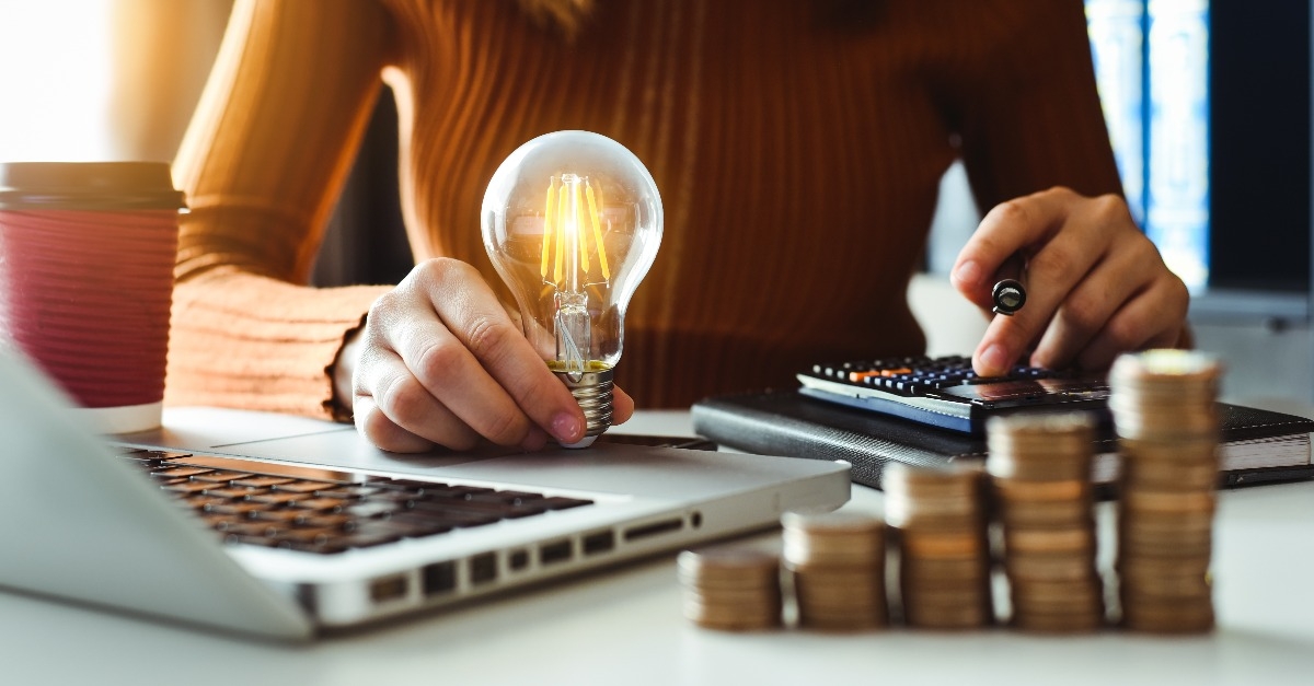 business man hand holding lightbulb 