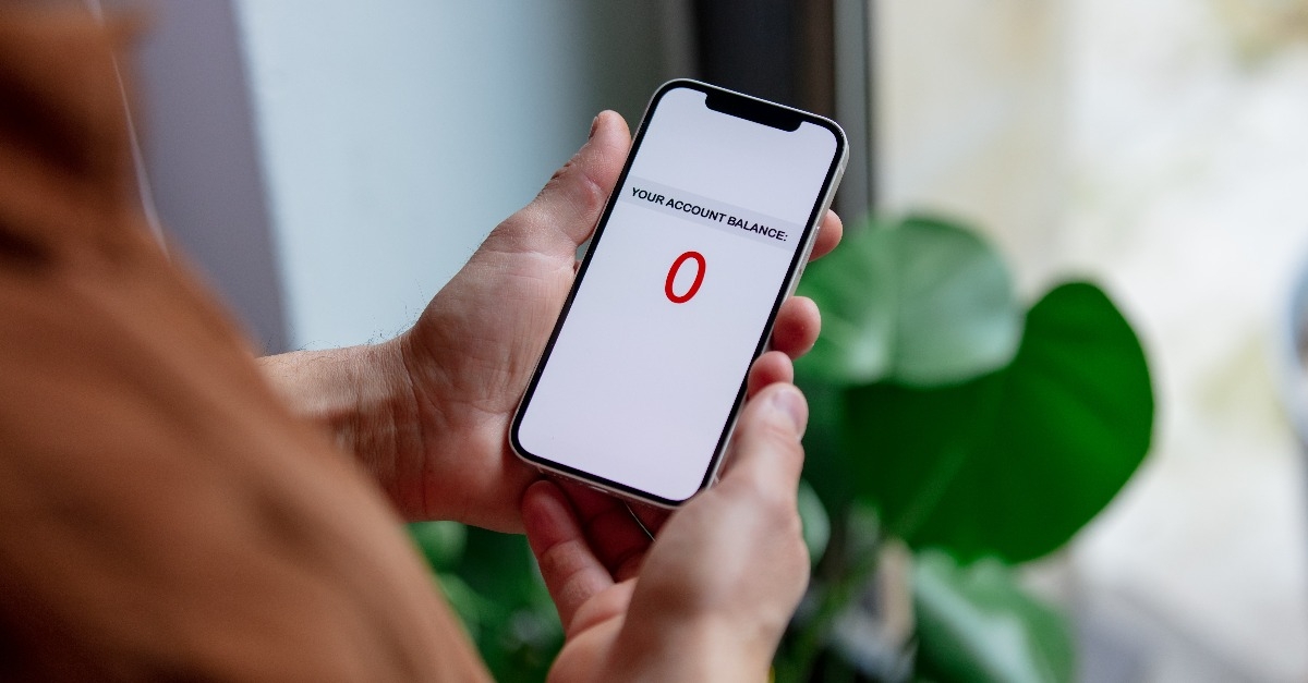 hand holds phone with information about the balance