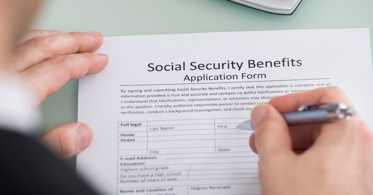 person hand filling social security benefits form