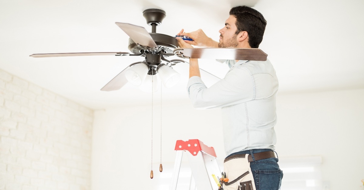 handyman installing a ceiling fan