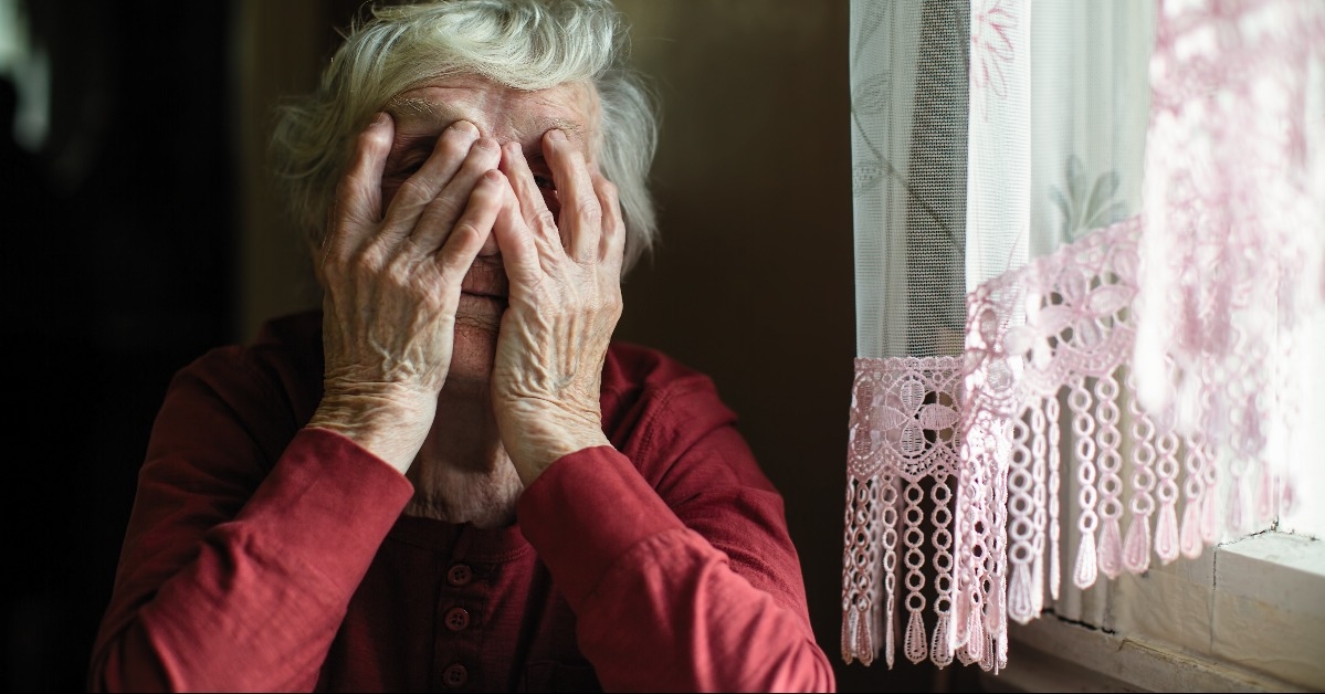 Emotions of elderly woman sitting at the table