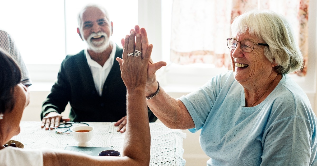 Senior women giving each other high five