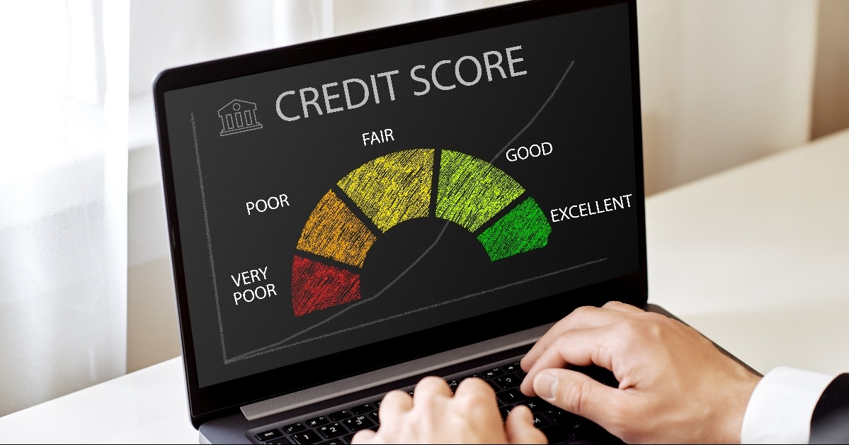 man looking at a laptop checks his credit history