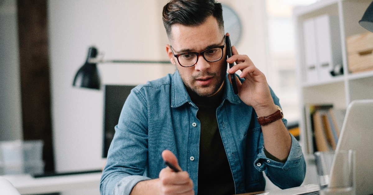 man talking on phone at work