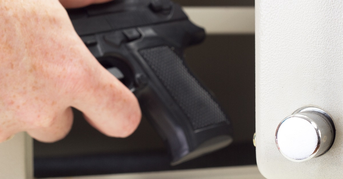 Person putting firearm in gun safe