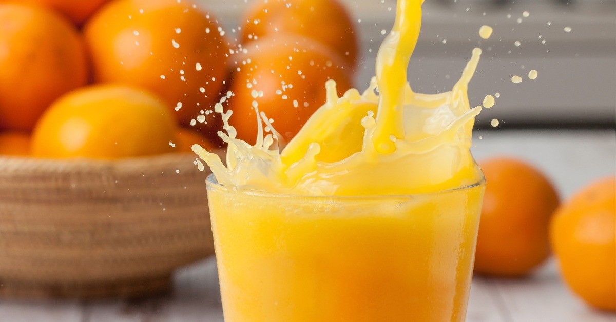 Orange juice pouring splash