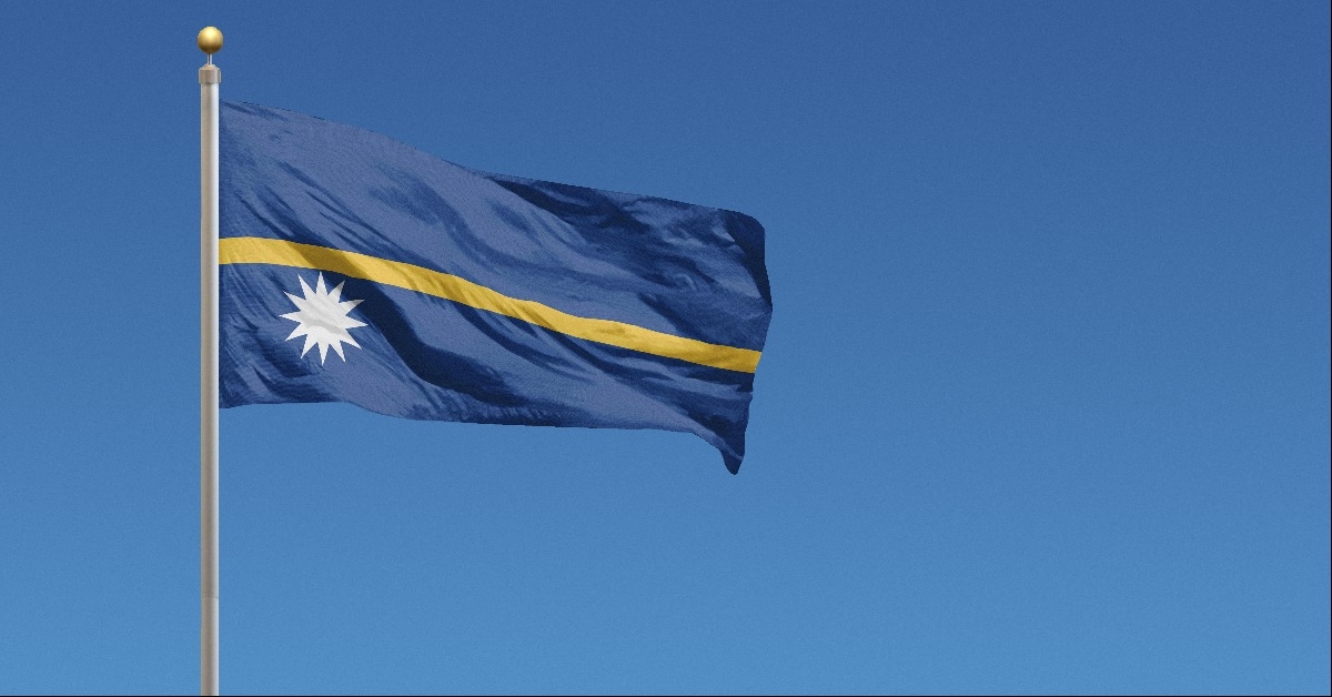 Nauru Flag in front of a clear blue sky