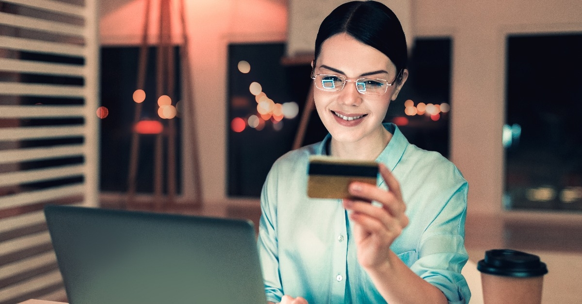  smiling girl shopping on the internet holding credit card