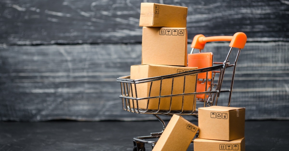 supermarket cart loaded with cardboard boxes