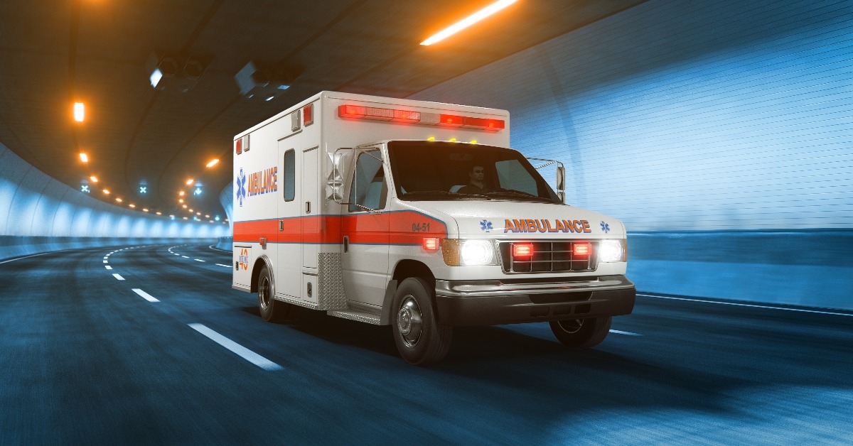 Ambulance car rides through tunnel warm yellow light