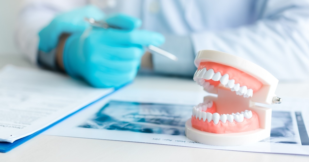 dentures with dentist working on table in clinic