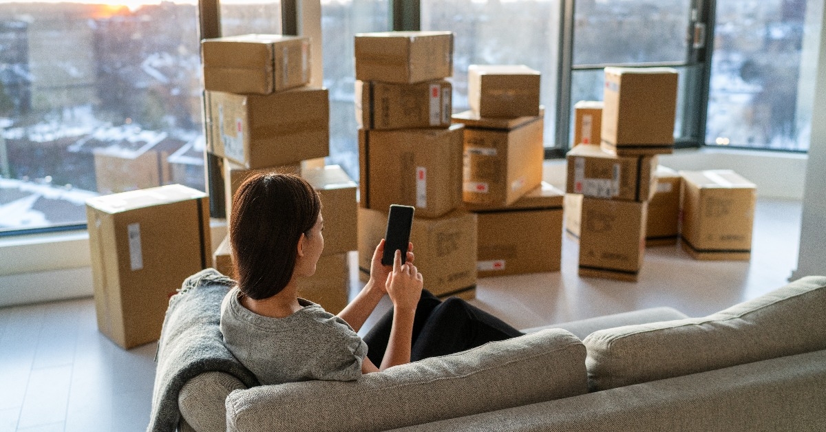 woman using online movers services on mobile phone app