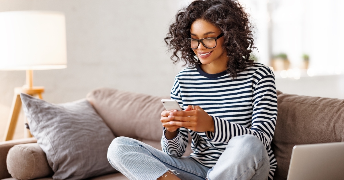 Woman smiling and looking at phone