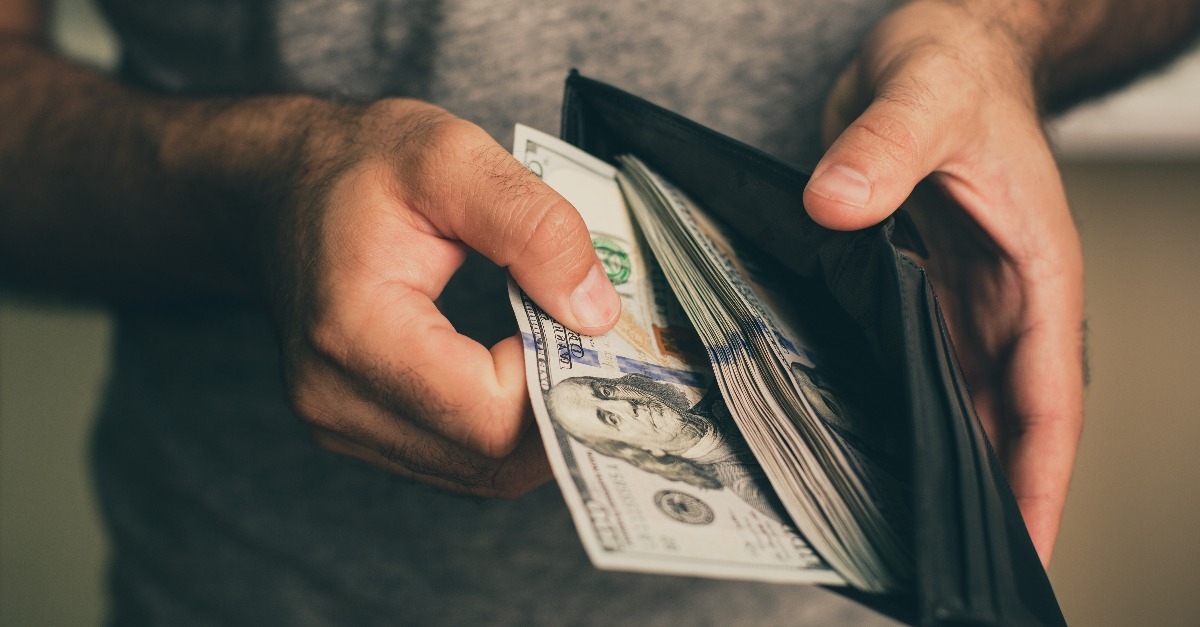 man looks in the wallet