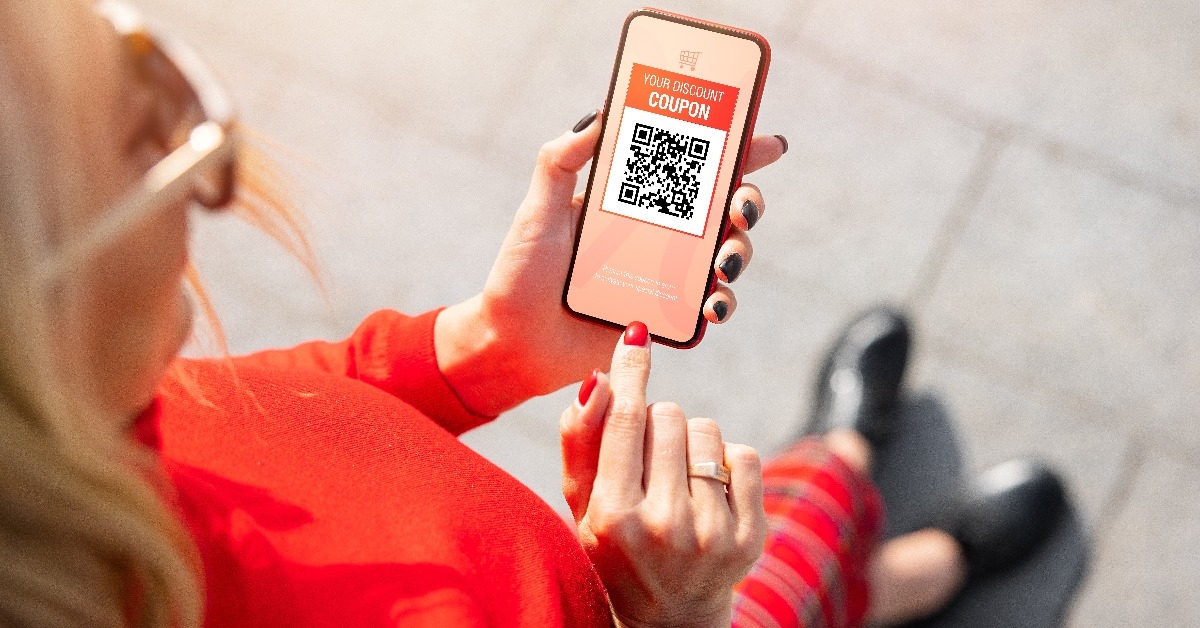 Woman viewing discount coupon on mobile phone