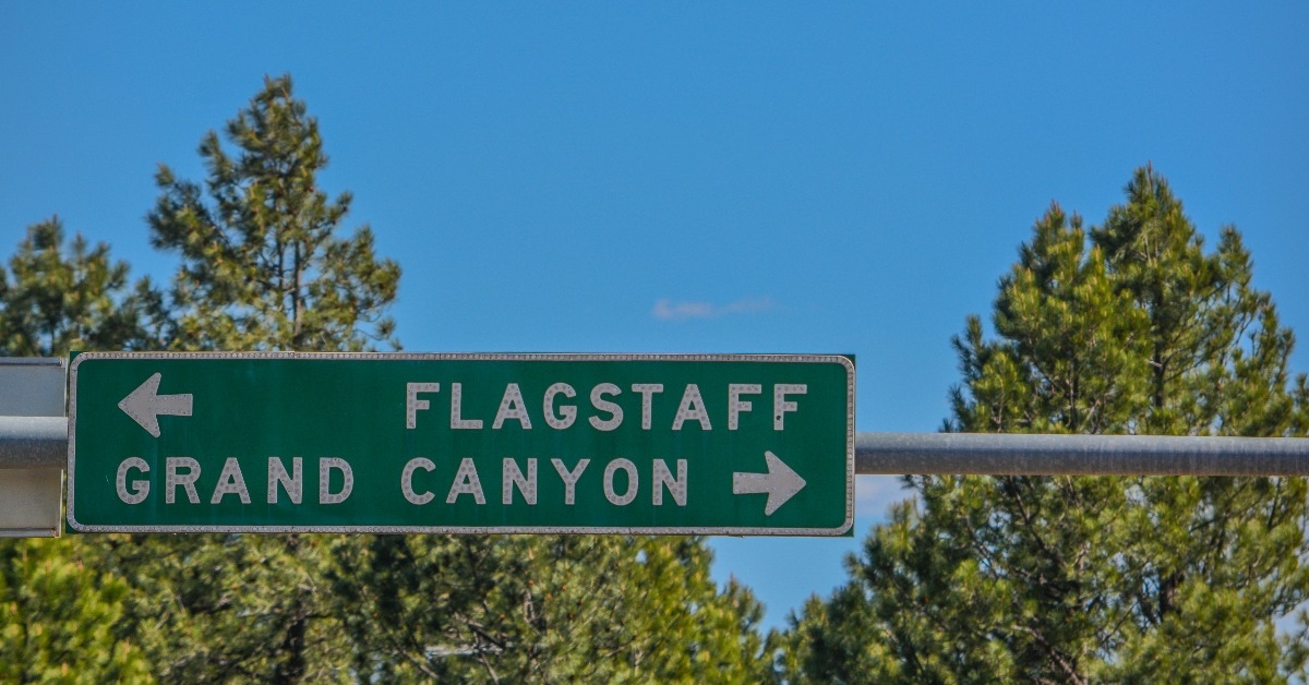 Flagstaff and Grand Canyon Road Sign in the Arizona Pine Forest