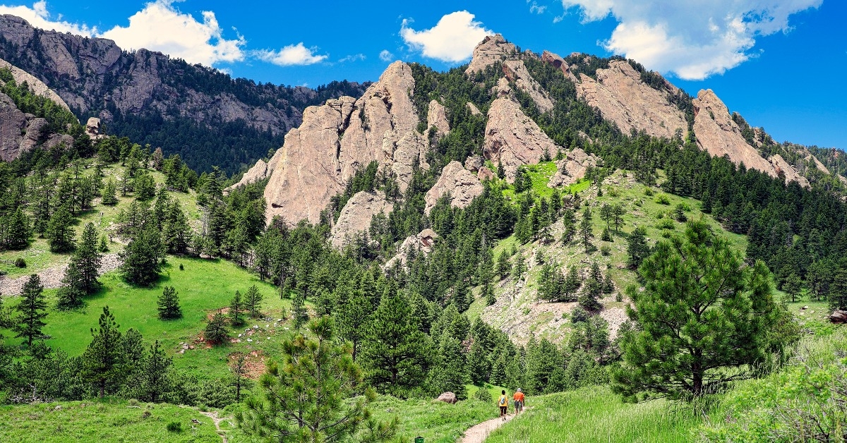 Hikers approach the Rocky Mountain foothills near Boulder Colorado
