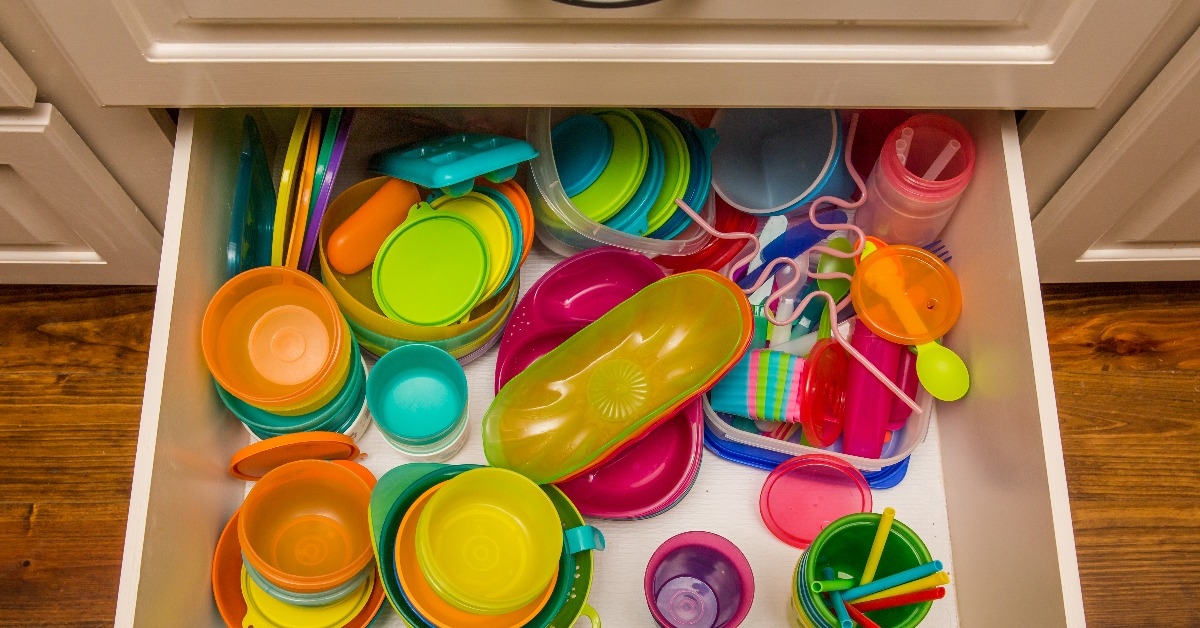 kitchen drawer filled with colorful plastic storage containers and cups