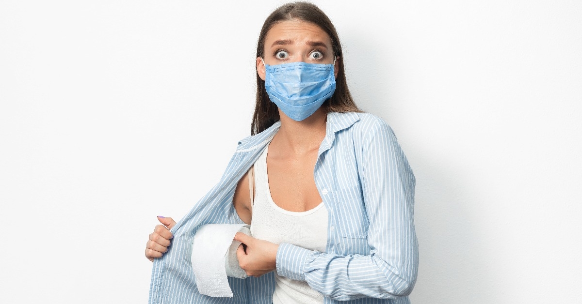 scared woman in mask stealing toilet paper