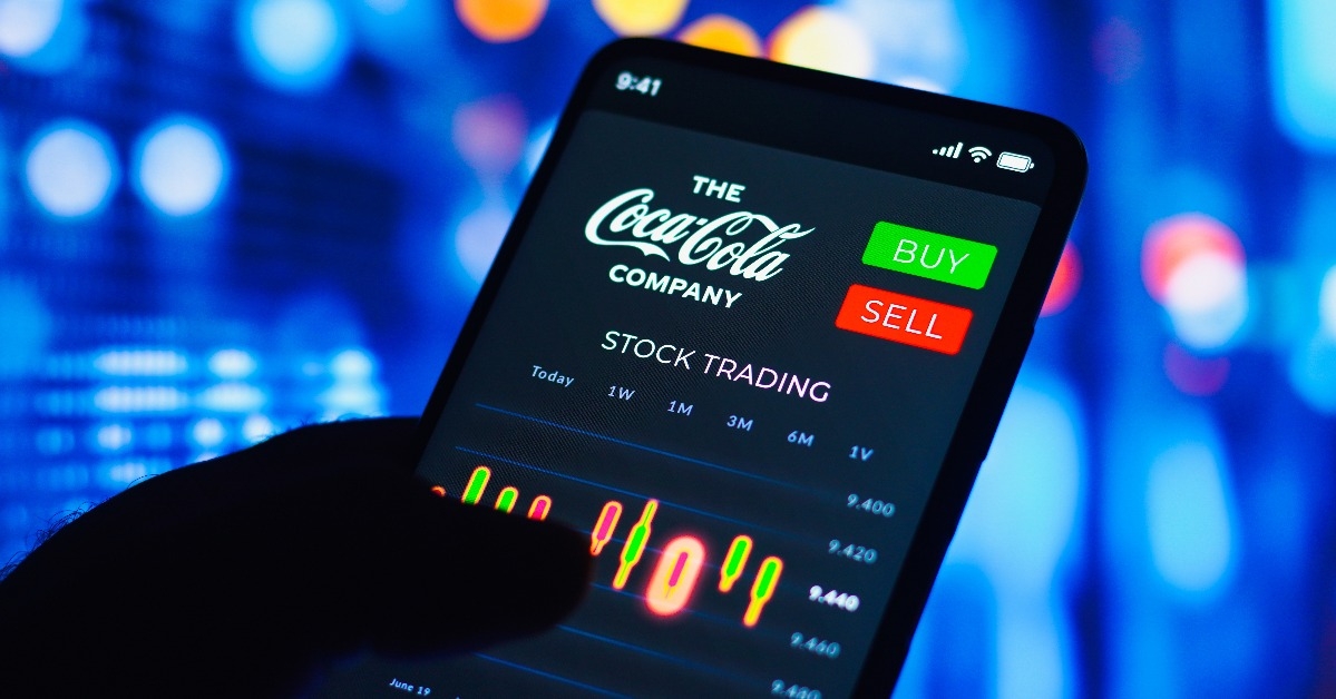 stock trading graph of Coca-Cola Company seen on a smartphone screen