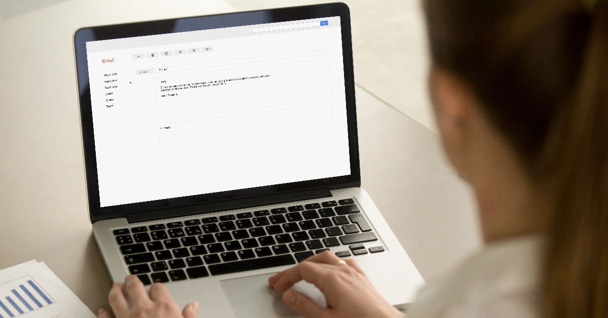 woman typing e-mail on laptop