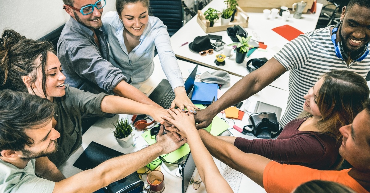  startup workers group stacking hands