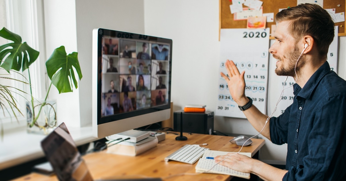 young man having Zoom video call via a computer in the home office