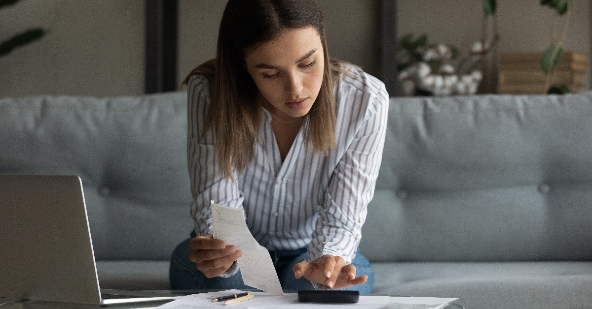 woman works with bills invoices at home office 
