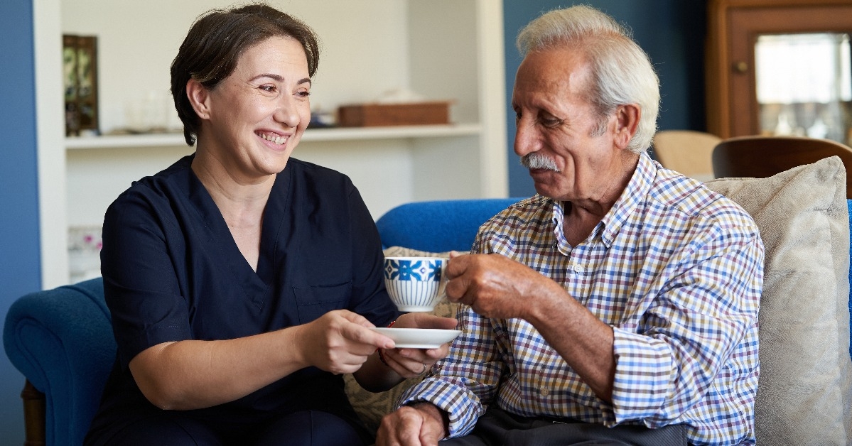 caregiver and a senior man during home visit