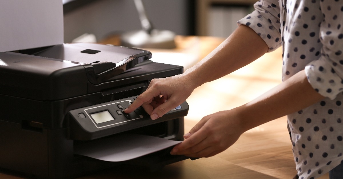 employee using modern printer in office 