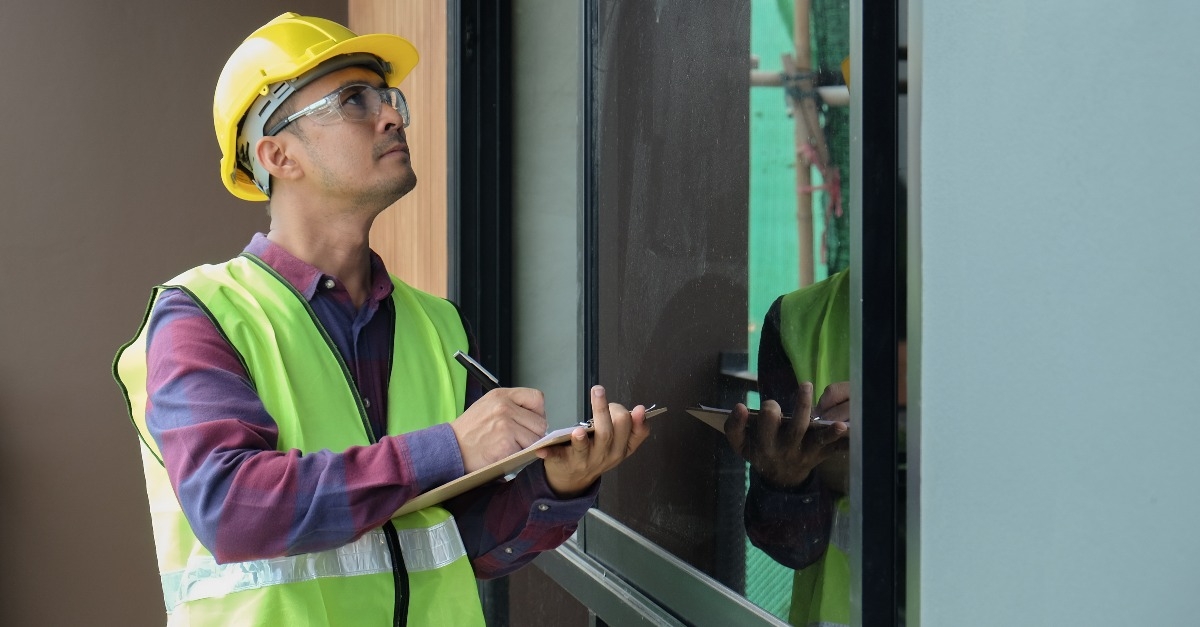 engineer in safety hardhat helmet and vest check quality and inspect building