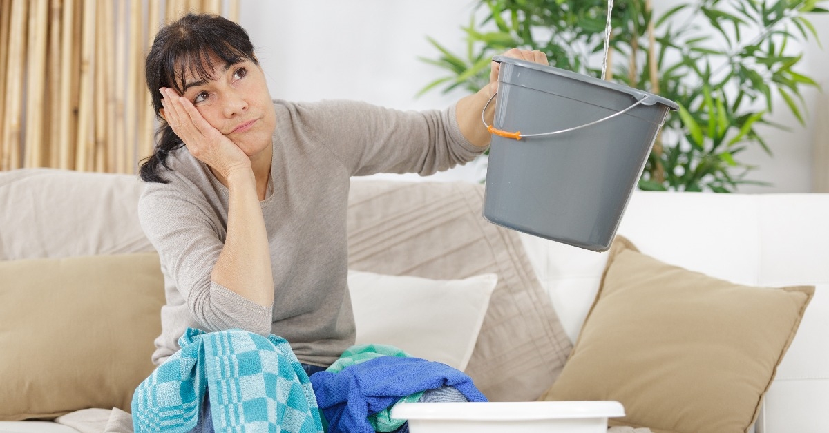 frustrated woman during leaking roof or pipe burst 