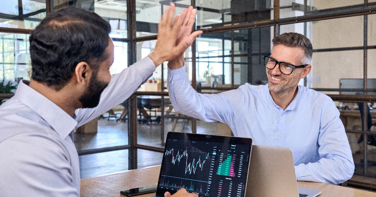 investors giving high five celebrating successful stock exchange trading deal 