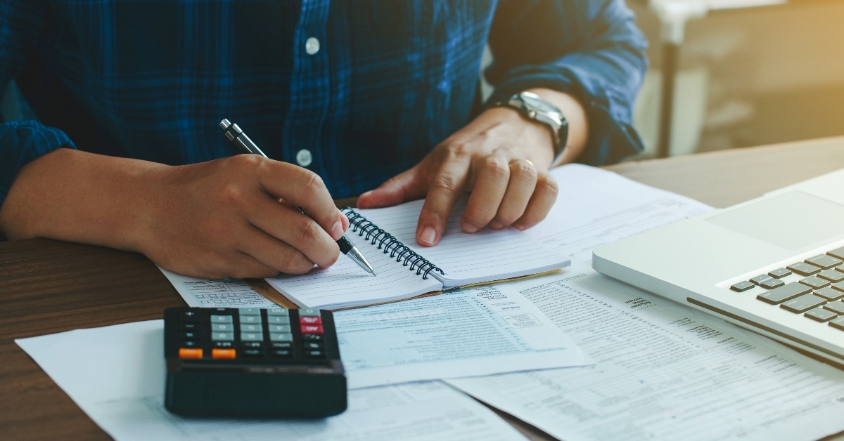 man doing finances and calculate about cost to real estate investment