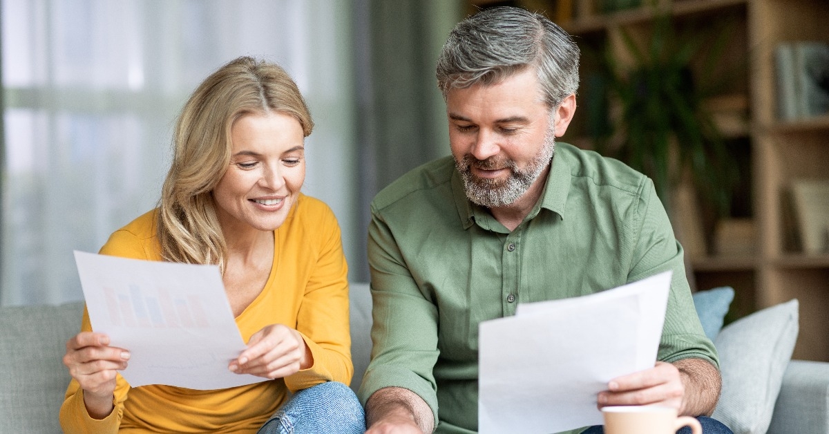 middle aged spouses checking financial documentation 