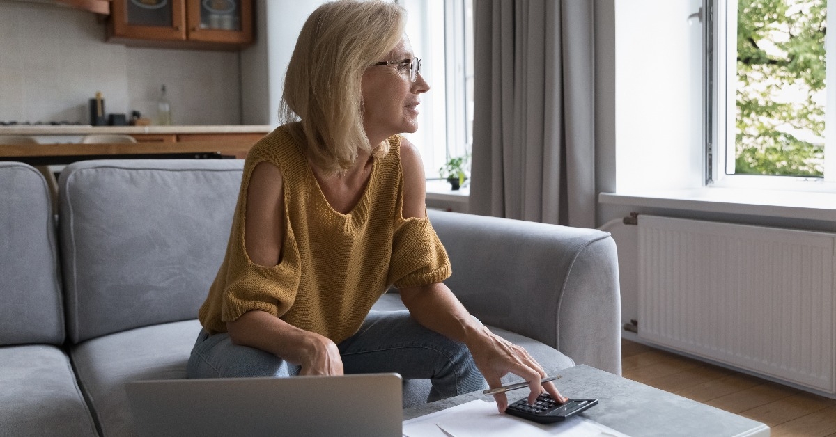 woman thinking over monthly paperwork