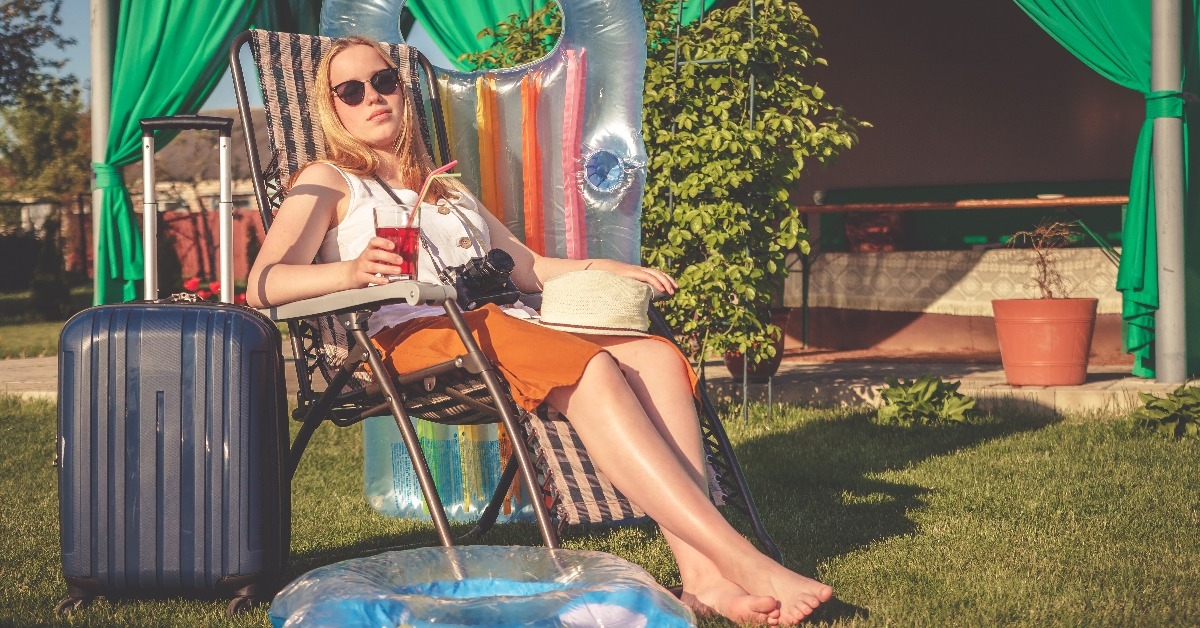 young woman traveler sitting in a beach chair 