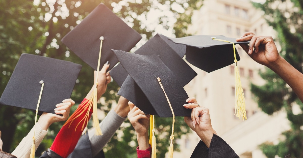 graduates throwing graduation caps in the air
