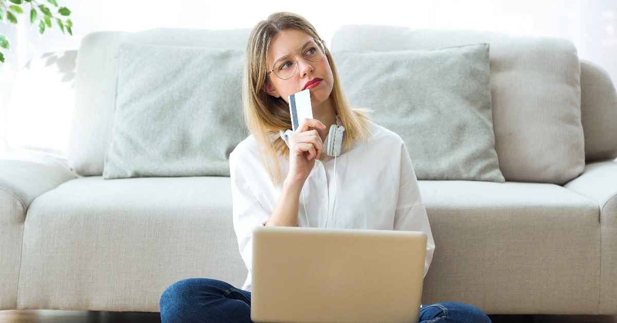 woman thinking about shopping something online 
