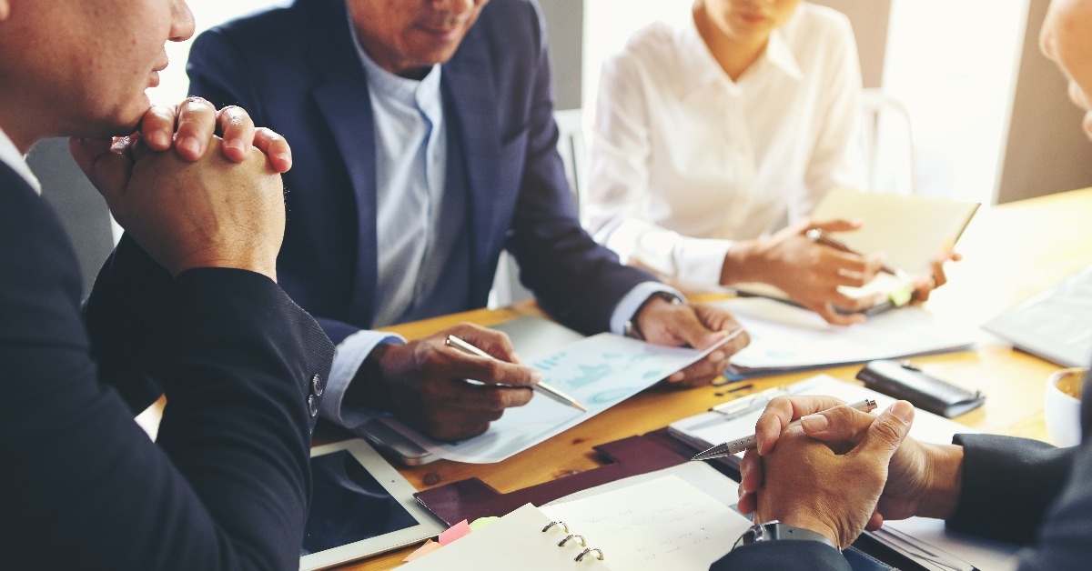 business people are meeting to analyze data for marketing plan